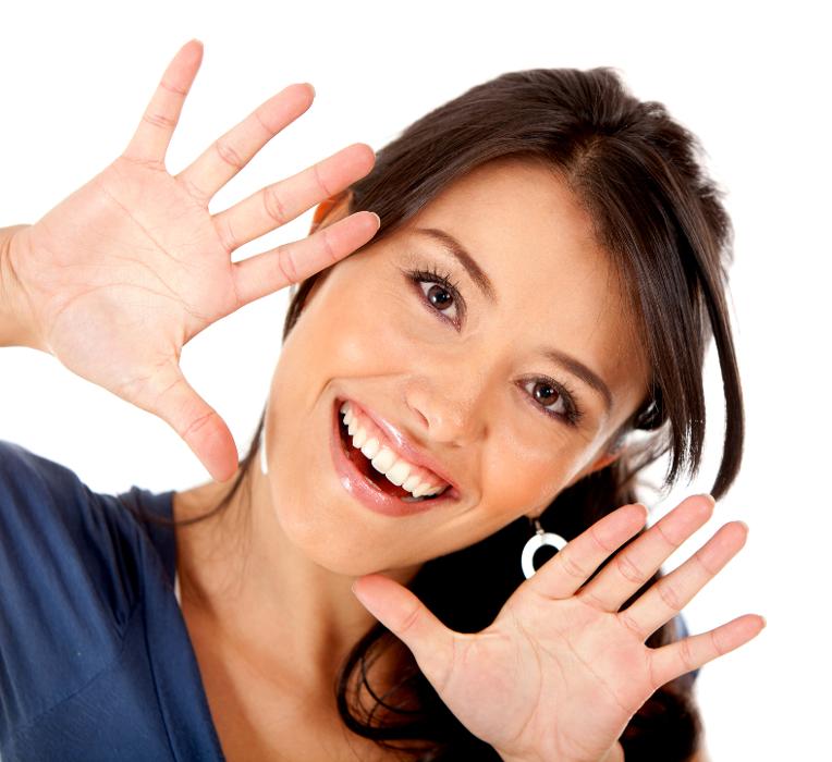 Smiling woman framing her face
