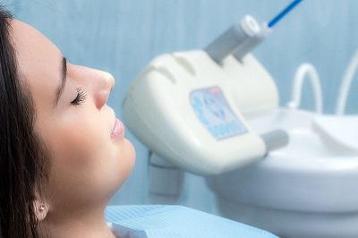 Woman closing her eyes during dental appointment