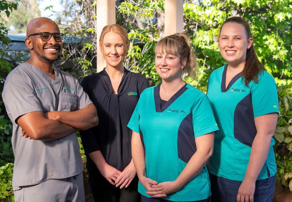 Dr. Nyepetsi smiling with his staff at Markham Street Dental