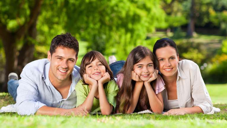 Smiling family in the grass