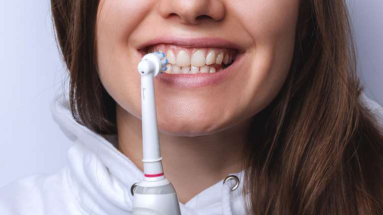Woman Holding Toothbrush