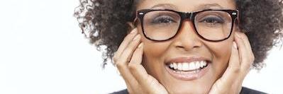 A woman with glasses smiling