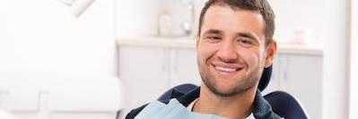 man smiling in dentist chair l armidale dental care