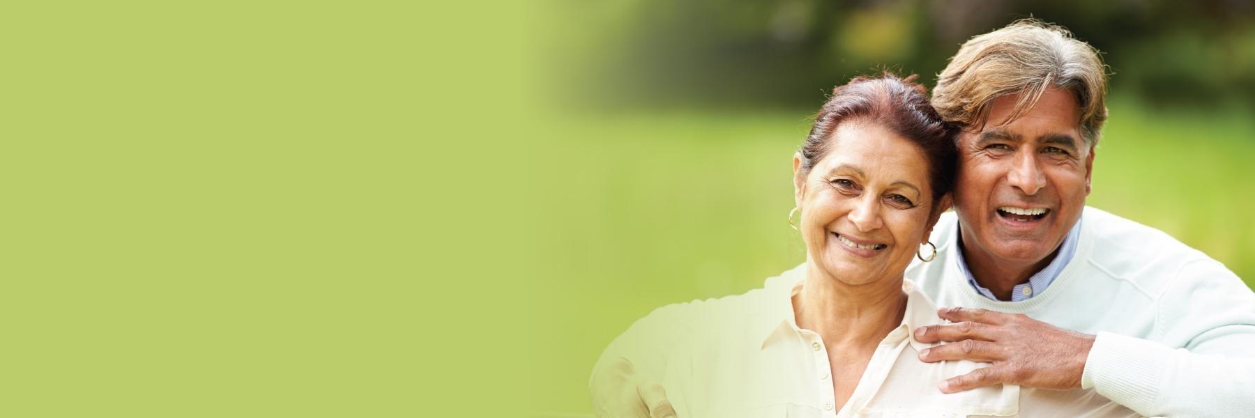 older couple hugging & smiling l periodontist armidale